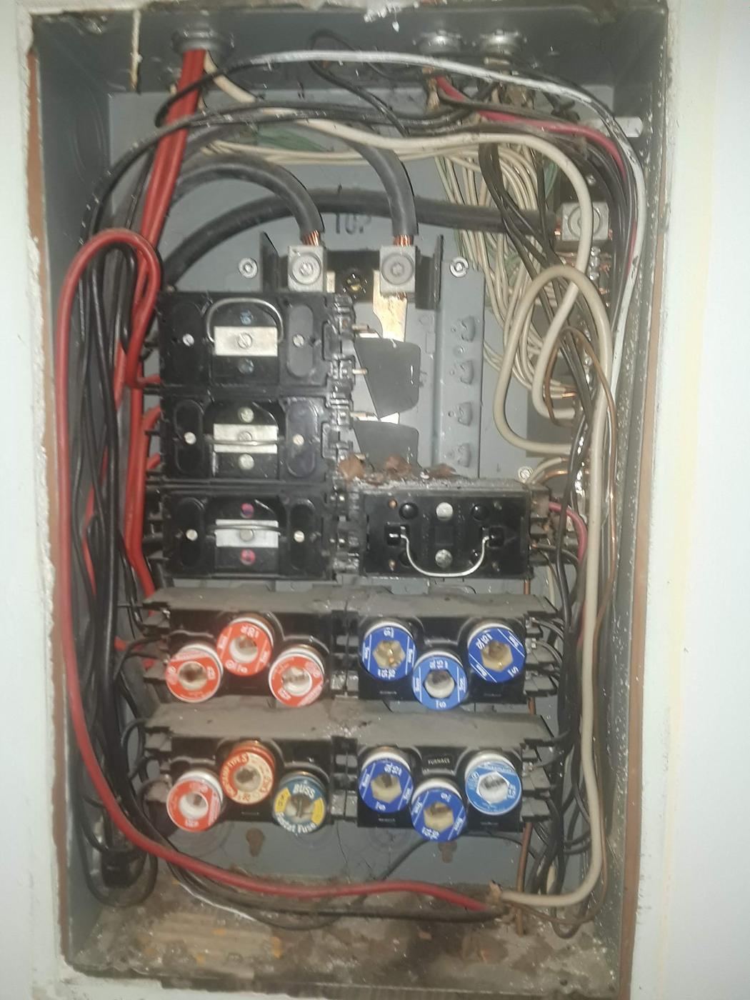 An old fuse box with screw in fuses, of the type replaced during a panel upgrade